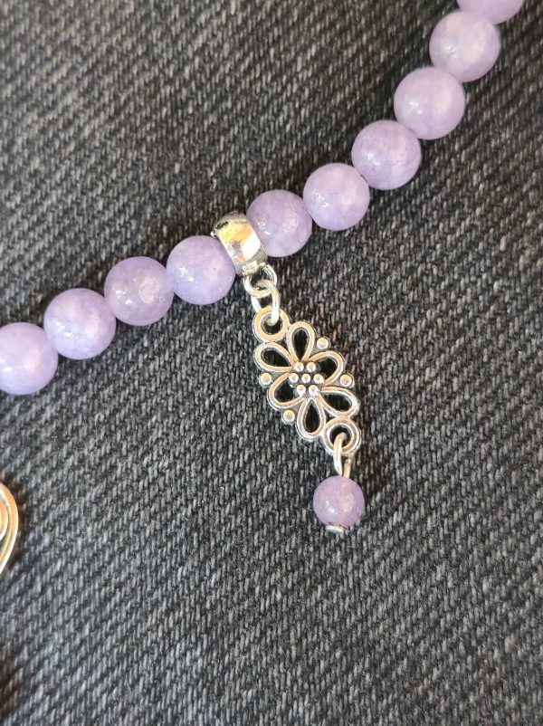 Ornate flower pendant with purple jade centerpiece