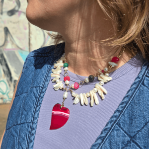 Close-up of model wearing heart-shaped natural stone necklace